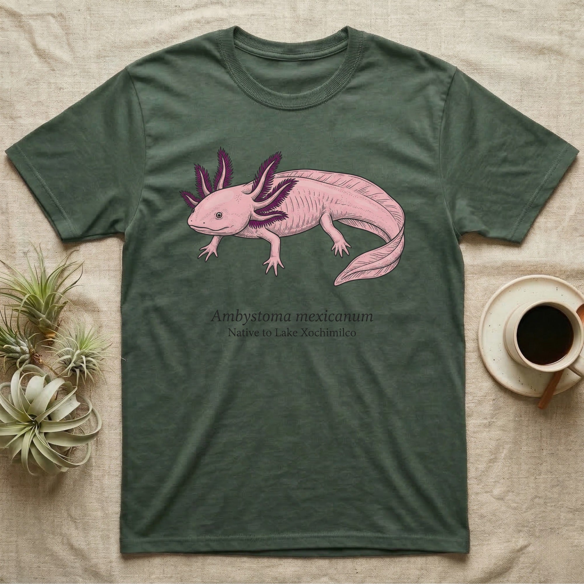 Green t-shirt with pink axolotl illustration and text "Ambystoma Mexicanum Native to Lake Xochimilco".