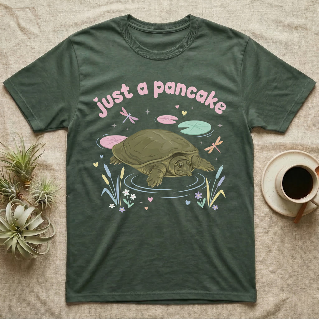 Spiny Softshell Turtle Baby T-Shirt in Military Green — Pastel spiny softshell turtle with flat shell and snorkel nose among lily pads, puffy pink wordmark "just a pancake" above.