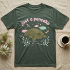Spiny Softshell Turtle Baby T-Shirt in Military Green — Pastel spiny softshell turtle with flat shell and snorkel nose among lily pads, puffy pink wordmark "just a pancake" above.