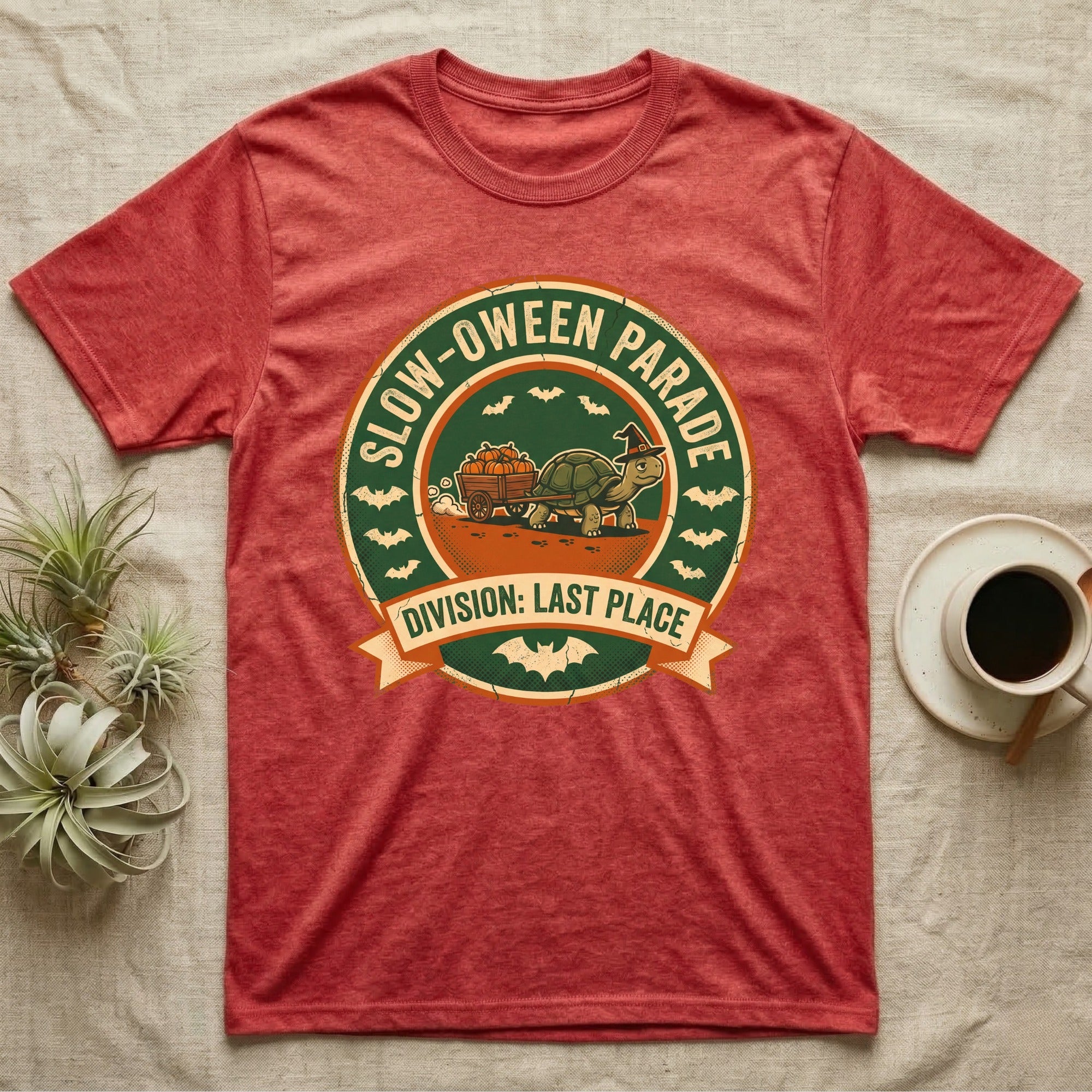 Tortoise Slow-oween Parade T-Shirt in Heather Red — Distressed badge of a witch-hatted tortoise pulling a pumpkin wagon, "Slow-oween Parade, Division Last Place."