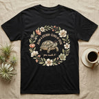 Slow And Steady Graduation T-Shirt in Black — Watercolour illustration of a tortoise in a graduation cap inside a floral wreath with "Slow & Steady, Class of 2026."