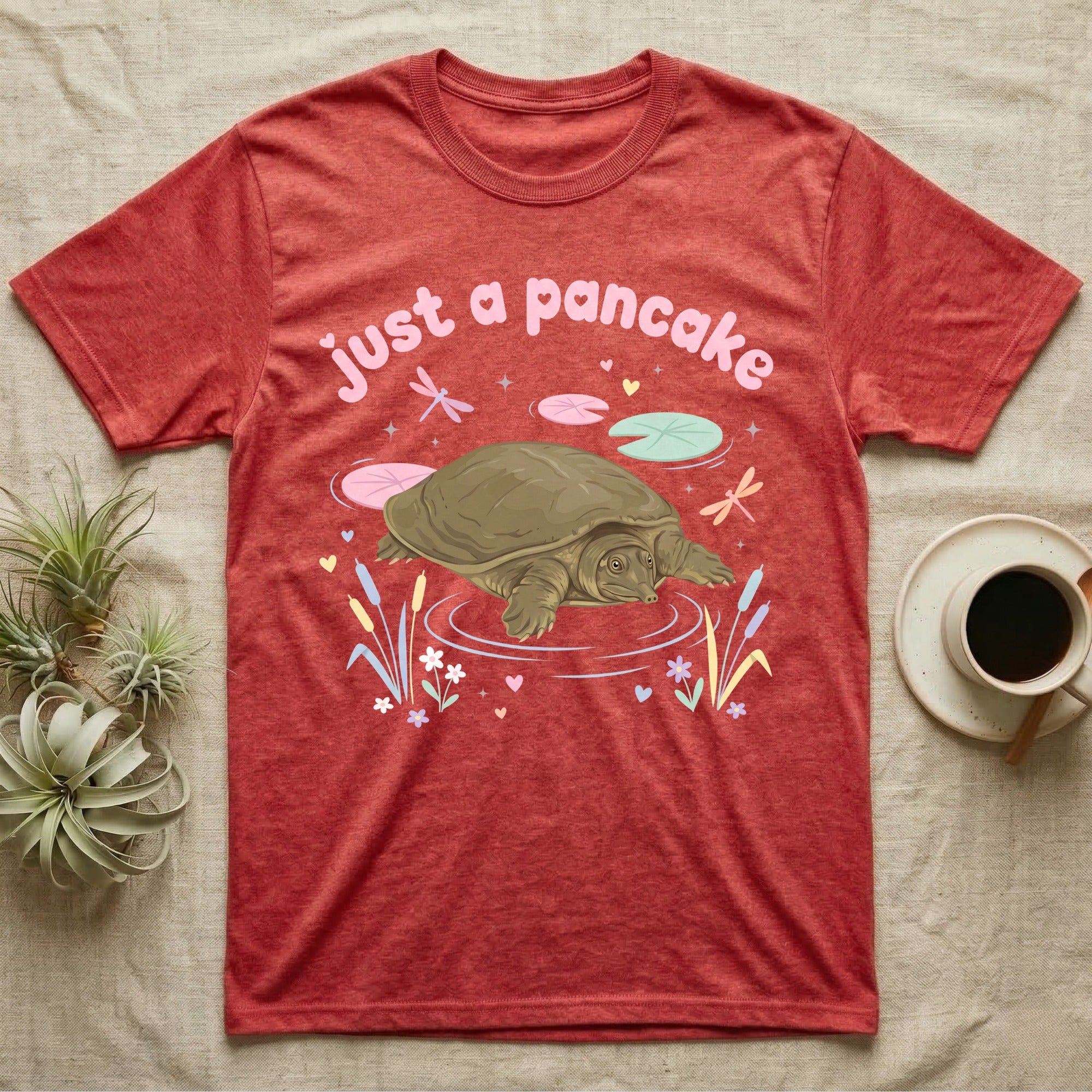 Spiny Softshell Turtle Baby T-Shirt in Heather Red — Pastel spiny softshell turtle with flat shell and snorkel nose among lily pads, puffy pink wordmark "just a pancake" above.