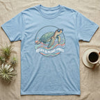 Blue t-shirt with a sea turtle wearing sunglasses on a circular design.