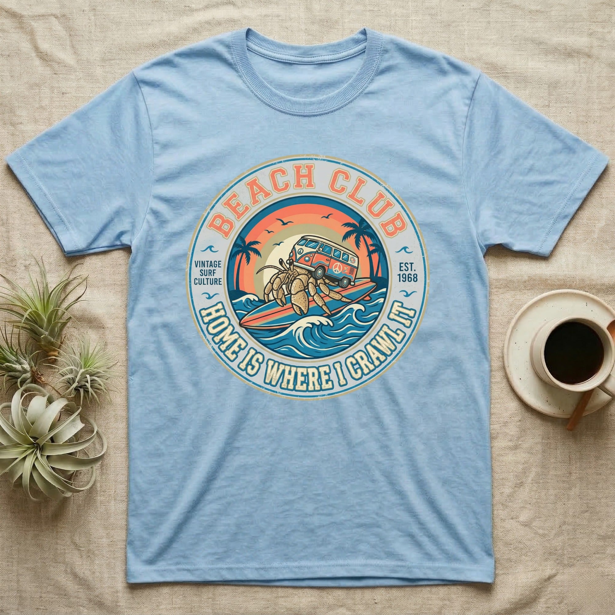 Light blue t-shirt with circular "Beach Club" graphic featuring a hermit crab driving a van.
