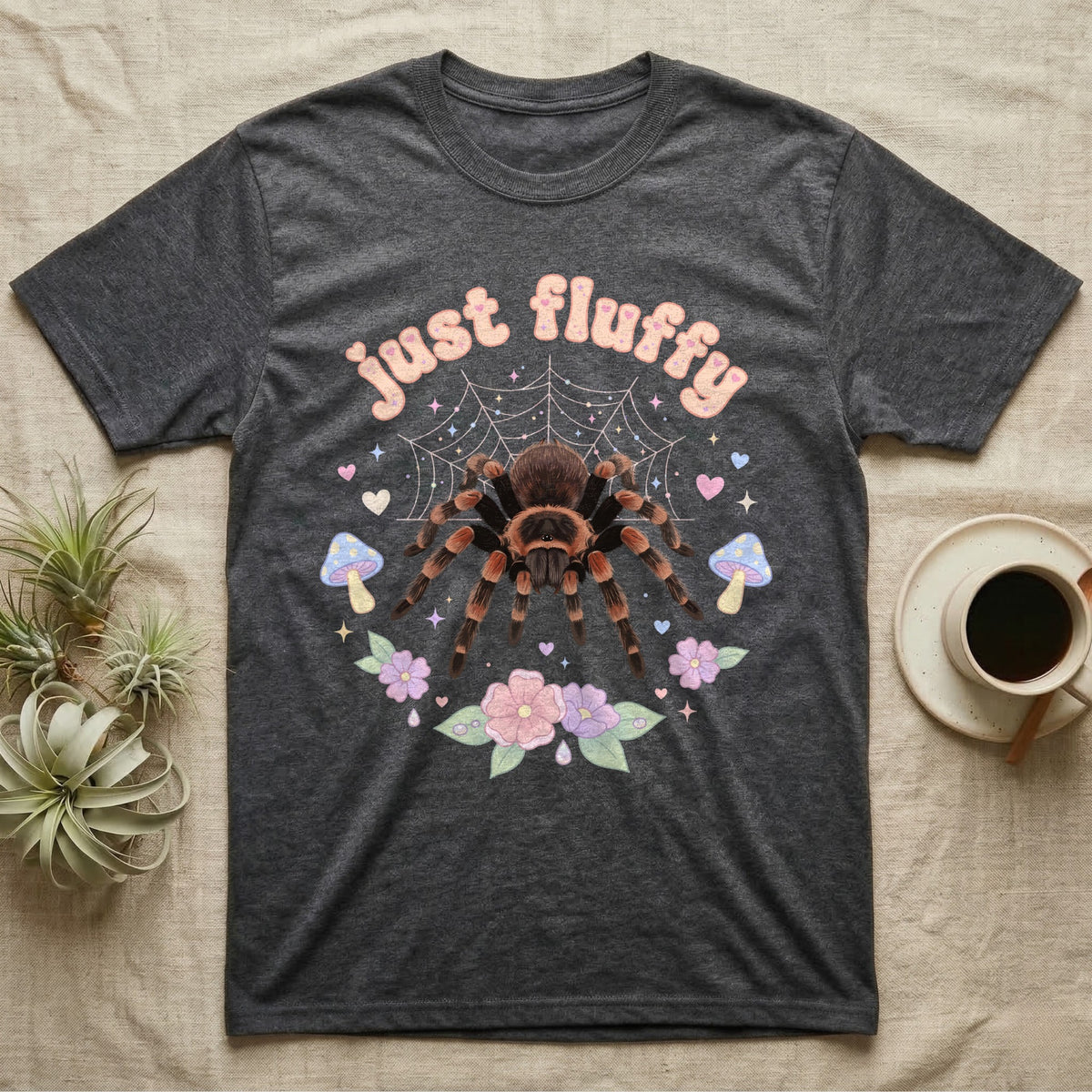 Mexican Redknee Tarantula Baby T-Shirt in Dark Heather — Fuzzy Mexican redknee tarantula on a pastel web with blossoms under puffy peach bubble text "just fluffy".