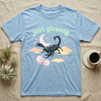 Emperor Scorpion Baby T-Shirt in Light Blue — Black emperor scorpion, pincers raised, under a pastel moon and stars with puffy mint bubble text "just glowing".