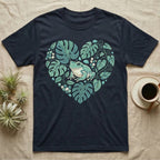 Dark t-shirt with a heart-shaped design of a frog and tropical leaves.