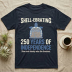 Sea Turtle Liberty Bell T-Shirt in Navy — Slate-blue and cream tee of a sea turtle whose shell is drawn as the Liberty Bell under Shell-Ebrating 250 Years text.