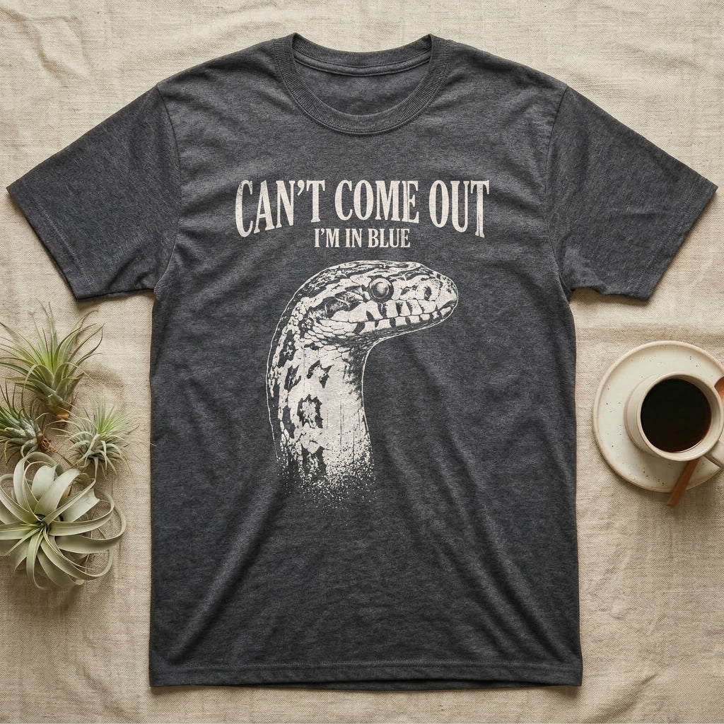 Corn Snake Shed T-Shirt in Dark Heather — Gritty white print of a corn snake head with milky pre-shed eyes under CAN'T COME OUT, I'M IN BLUE, on black