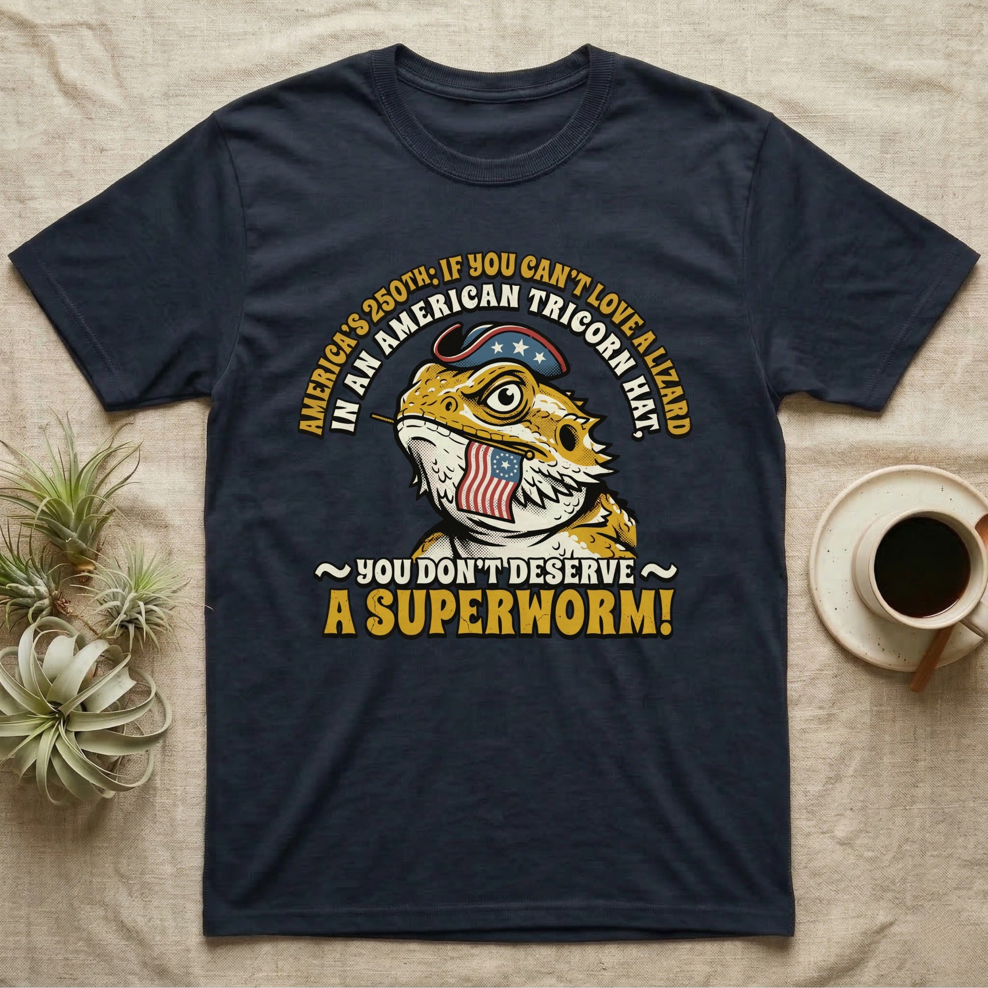 Bearded Dragon Tricorn Tee in Navy — Bold woodcut tee of a bearded dragon in a colonial tricorn hat, gold and cream text reading You Don't Deserve A Superworm, on black.