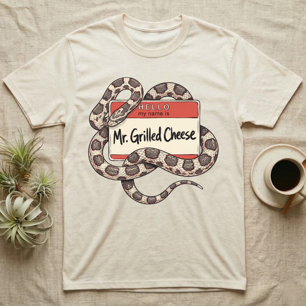 Grilled Cheese Corn Snake T-Shirt in Natural — Flat retro illustration of a corn snake coiled through a "Hello my name is Mr. Grilled Cheese" name-tag badge.