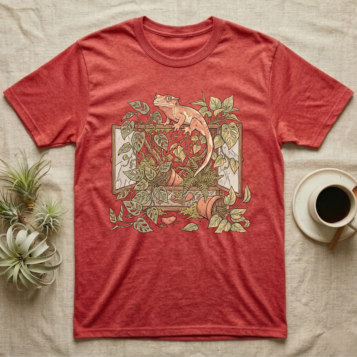 Bioactive Crested Gecko T-Shirt in Heather Red — Botanical illustration of a smug crested gecko perched atop a lush overgrown planted vivarium spilling vines.