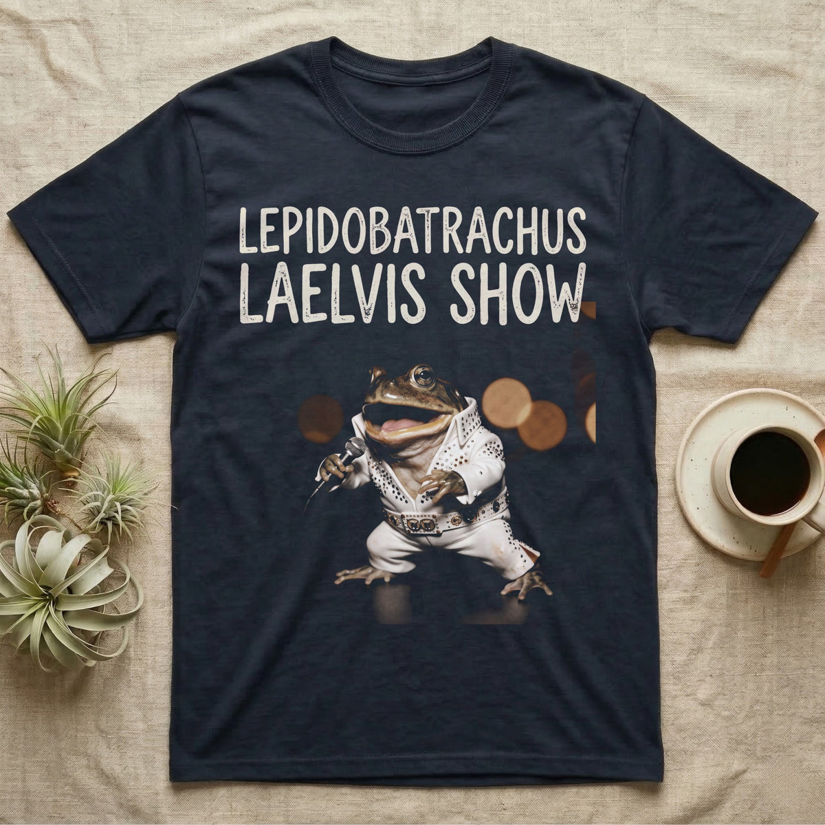 Budgett's Frog Rock Star T-Shirt in Navy — Budgett's frog in a white rhinestone stage jumpsuit singing into a microphone under a Lepidobatrachus Laelvis Show headline.