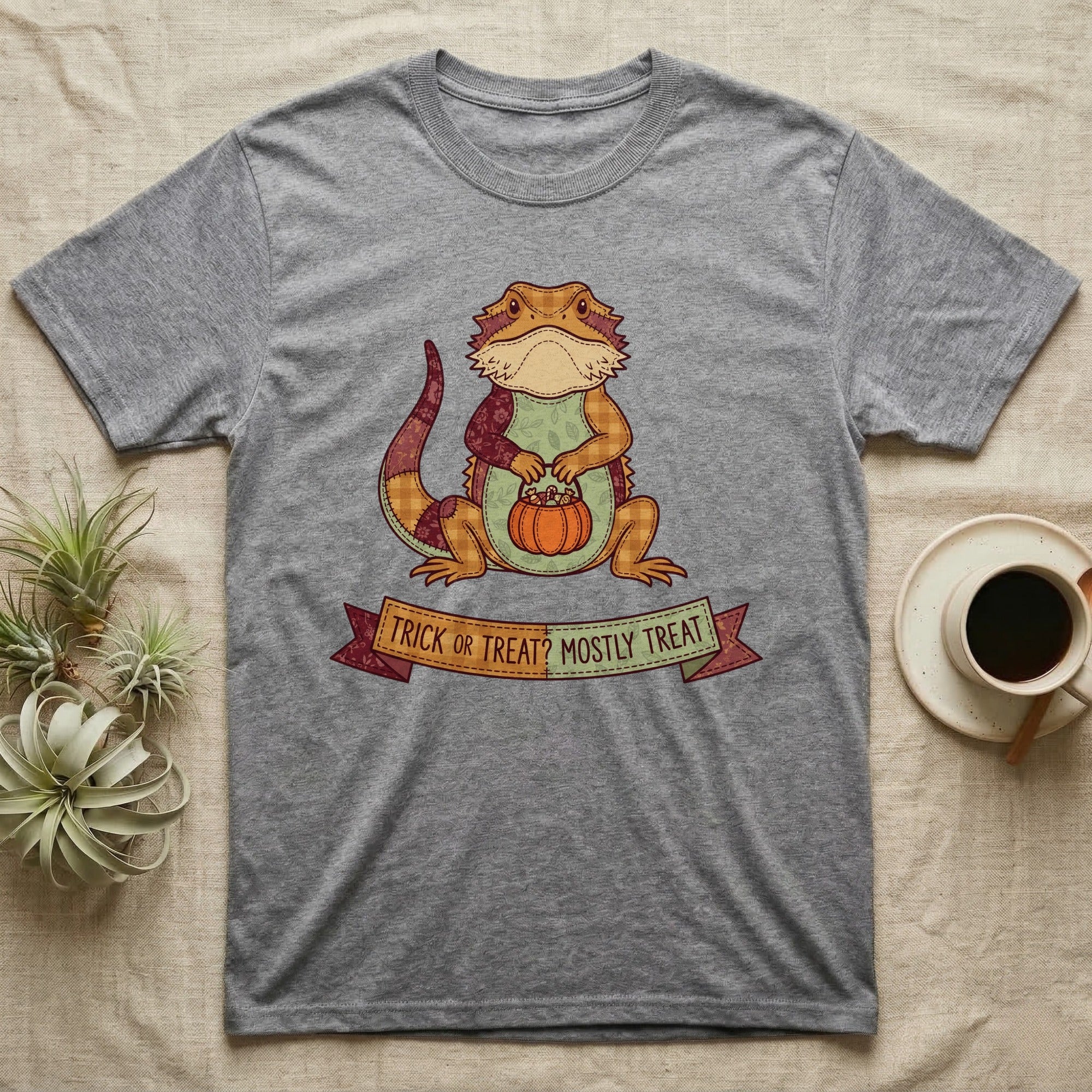 Bearded Dragon Mostly Treat T-Shirt in Sport Grey — Patchwork-quilt bearded dragon holding a pumpkin pail, banner reading "Trick or Treat? Mostly Treat."
