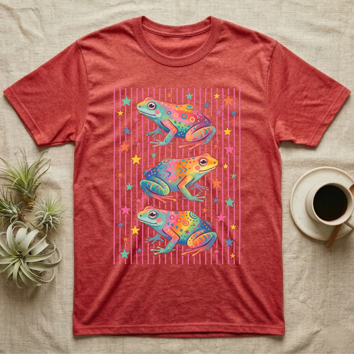 Dart Frog Disco Stripes T-Shirt in Heather Red — Three rainbow poison dart frog morphs stacked on a pink-and-cream candy-stripe field with scattered stars.