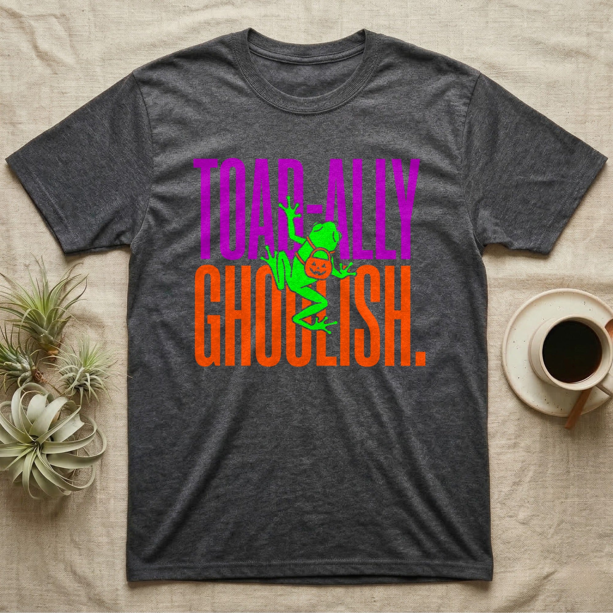 Tree Frog Toad-ally Ghoulish T-Shirt in Dark Heather — Neon green tree frog with a pumpkin pail clinging across stacked text, "Toad-ally Ghoulish."