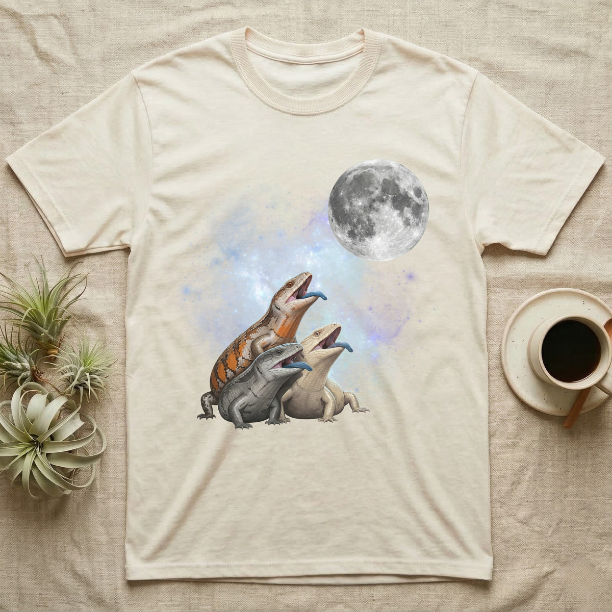 Blue-Tongued Skink Moon Howl T-Shirt in Natural — Three Blue-Tongued Skink colour morphs howling at a full moon over a nebula on a dark grey t-shirt.