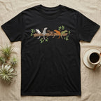 Crested Gecko Morph Line T-Shirt in Black — Five crested gecko morphs in ink and watercolour perched along one cork bark branch with ficus leaves.