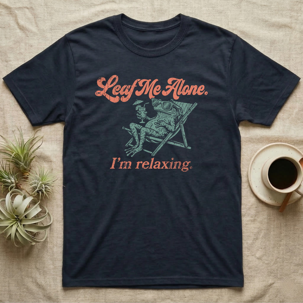 Solomon Islands Leaf Frog Chillin T-Shirt in Navy — Illustrated Solomon Islands leaf frog reclining in a beach chair with sunglasses and a cocktail, coral script reading Leaf Me Alone I'm Relaxing.