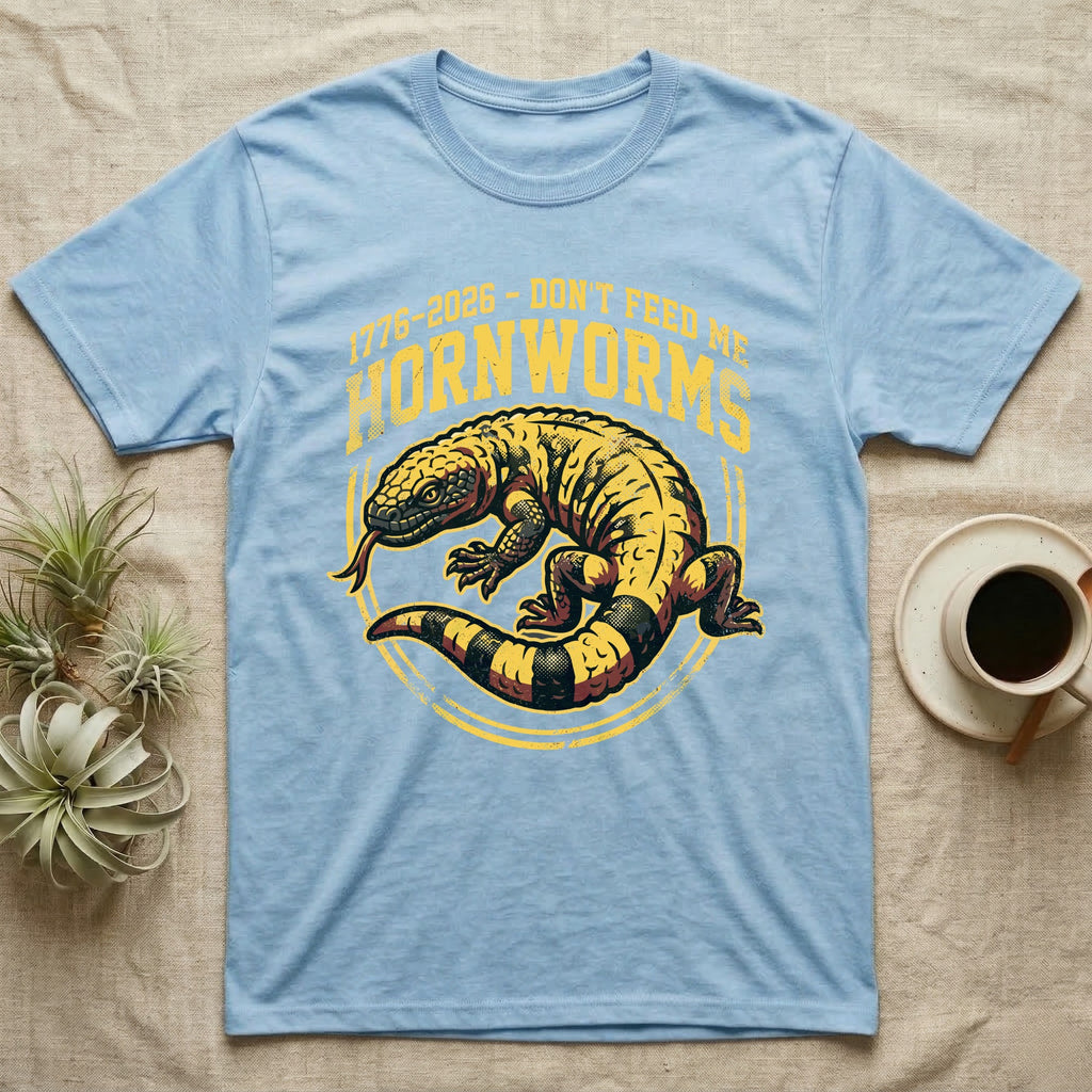 Gila Monster Hornworms Tee in Light Blue — Bold gold and maroon woodcut tee of a Gila monster with banded tail, large text reading Don't Feed Me Hornworms, on black.