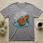 Capybara in hot springs with orange on head and steam, next to Japanese garden.