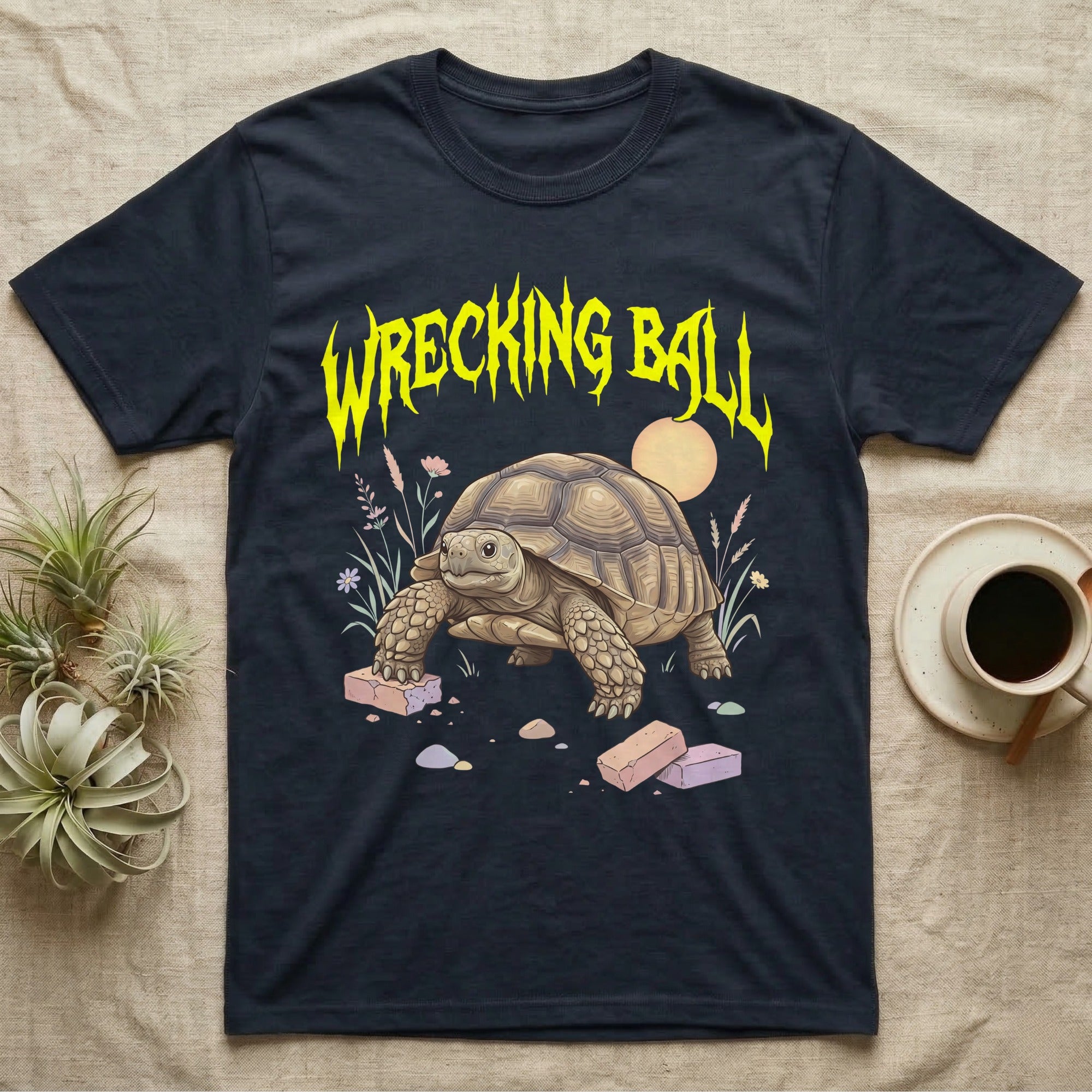 Sulcata Tortoise Feral T-Shirt in Navy — Sulcata tortoise plodding over crumbled bricks under a jagged caution-yellow metal "WRECKING BALL" wordmark.