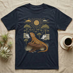 Bearded Dragon Home Range T-Shirt in Navy — Woodcut-style illustration of a bearded dragon basking on a boulder under a full sun with arid scrub trees and escarpments behind, no on-shirt text.