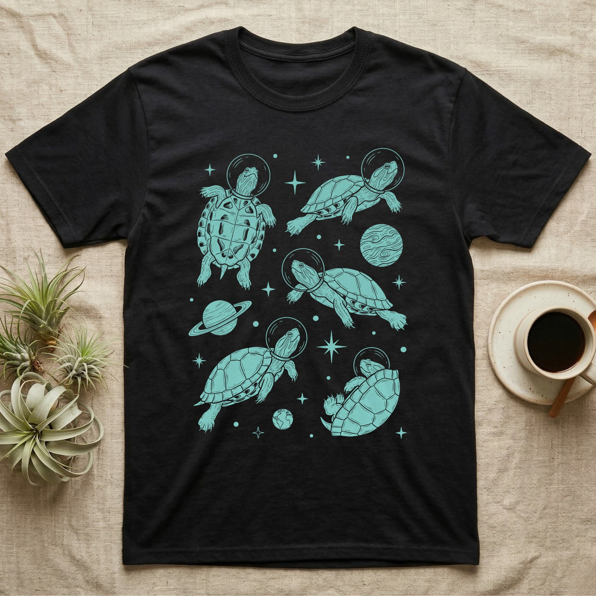 Red Eared Slider Cosmic T-Shirt in Black — Vintage screen-print illustration of red-eared slider turtles in astronaut helmets floating in space, cosmic teal monochromatic on dark background.