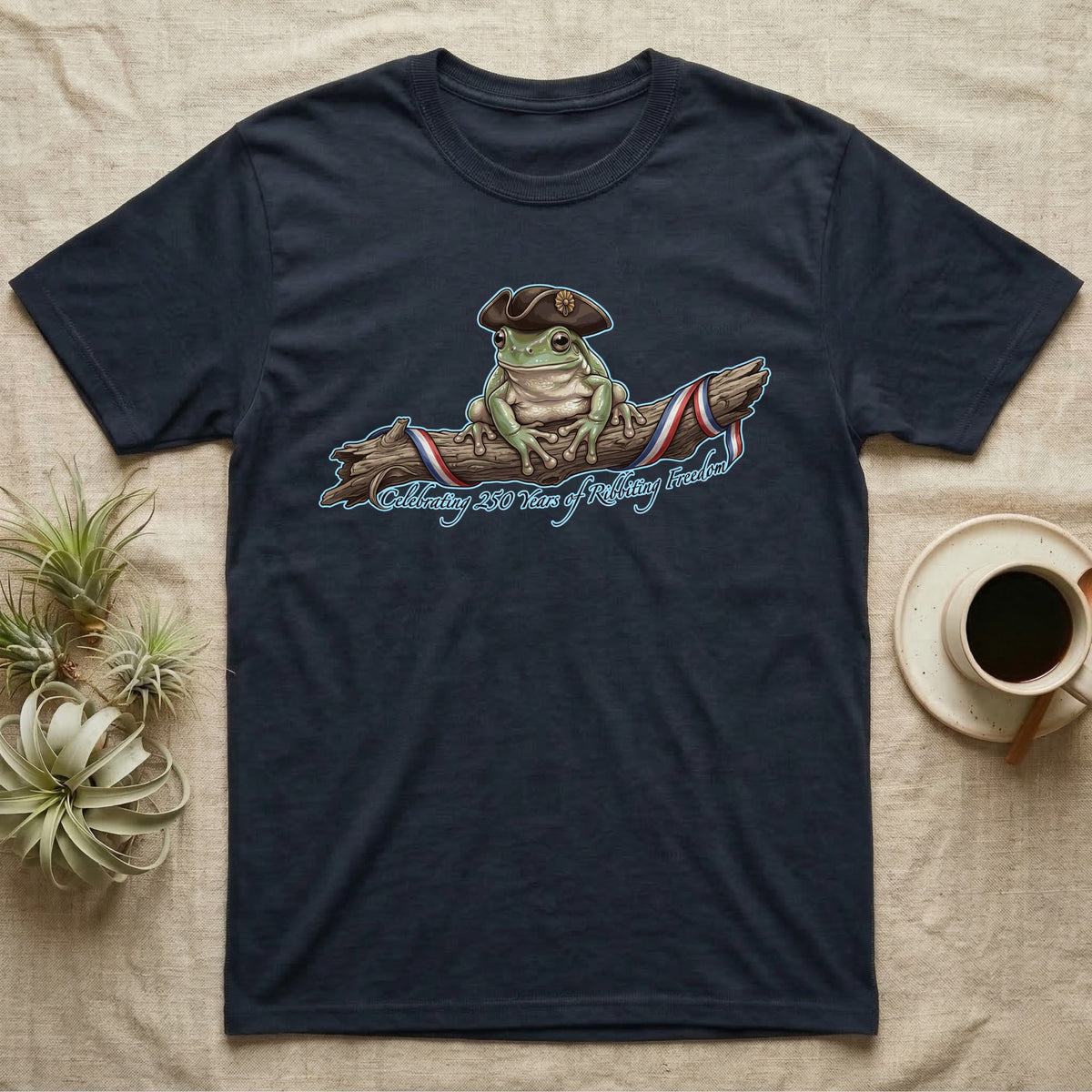 Tree Frog Freedom T-Shirt in Navy — Detailed green tree frog in a tricorn hat on a ribboned branch under script Celebrating 250 Years of Freedom.