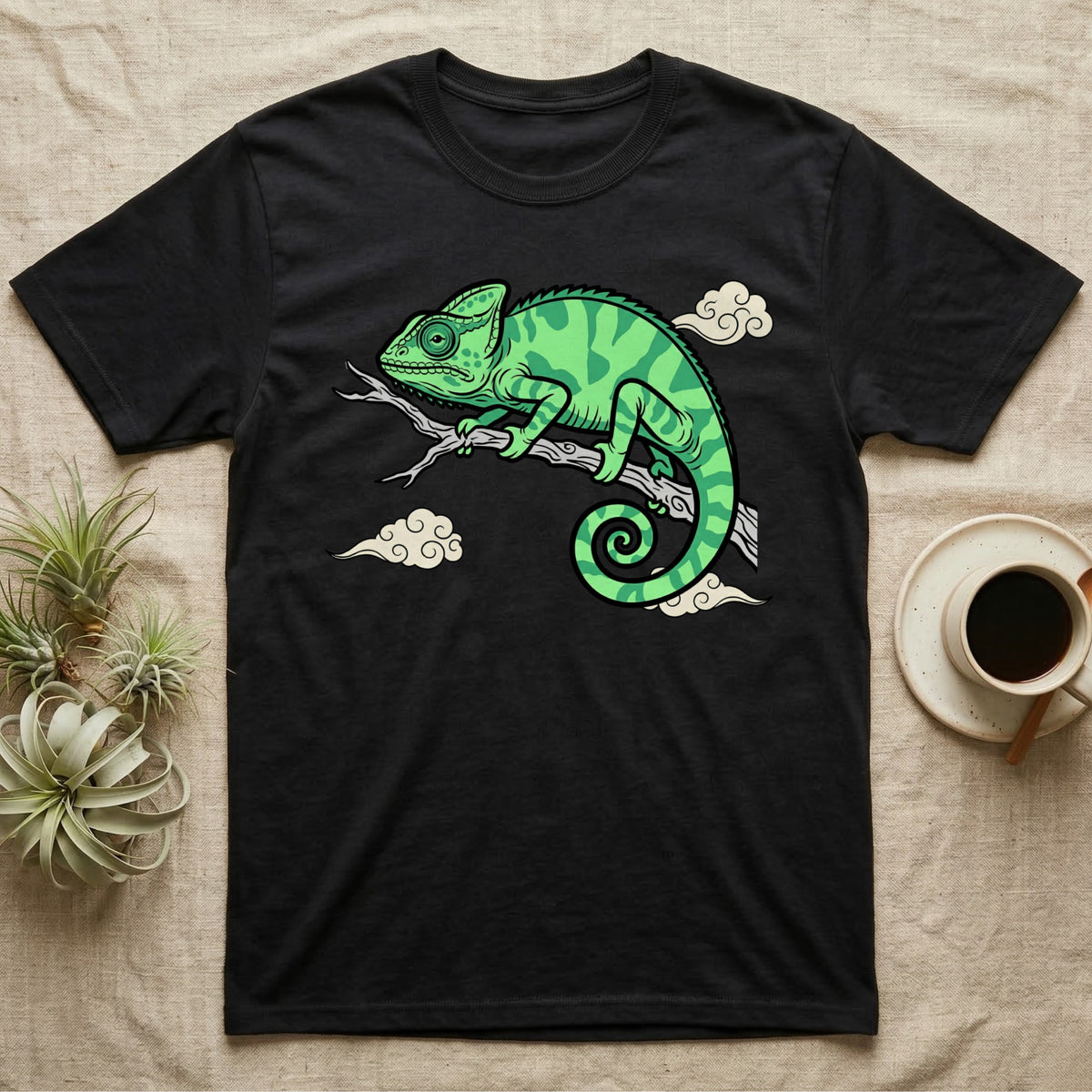 Black t-shirt with green chameleon on a branch graphic.