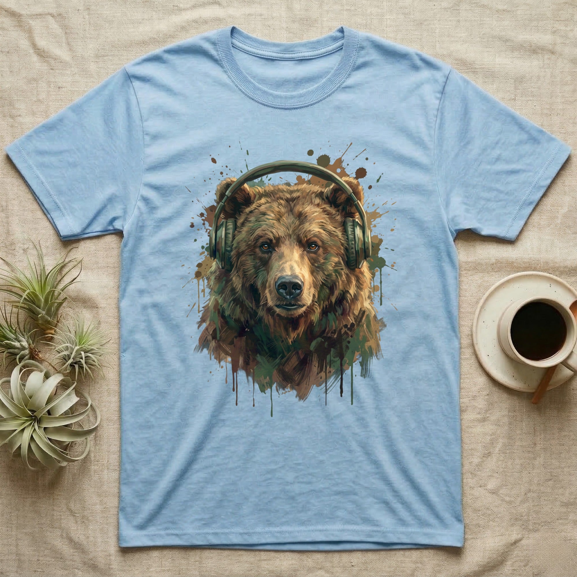 Light blue t-shirt featuring a painted bear wearing headphones.