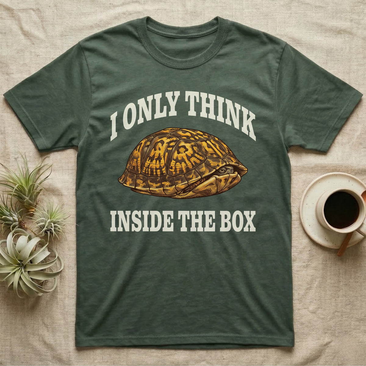 Box Turtle Thinker T-Shirt in Military Green — Engraved eastern box turtle shut in its shell, one eye peeking out, under I Only Think Inside the Box