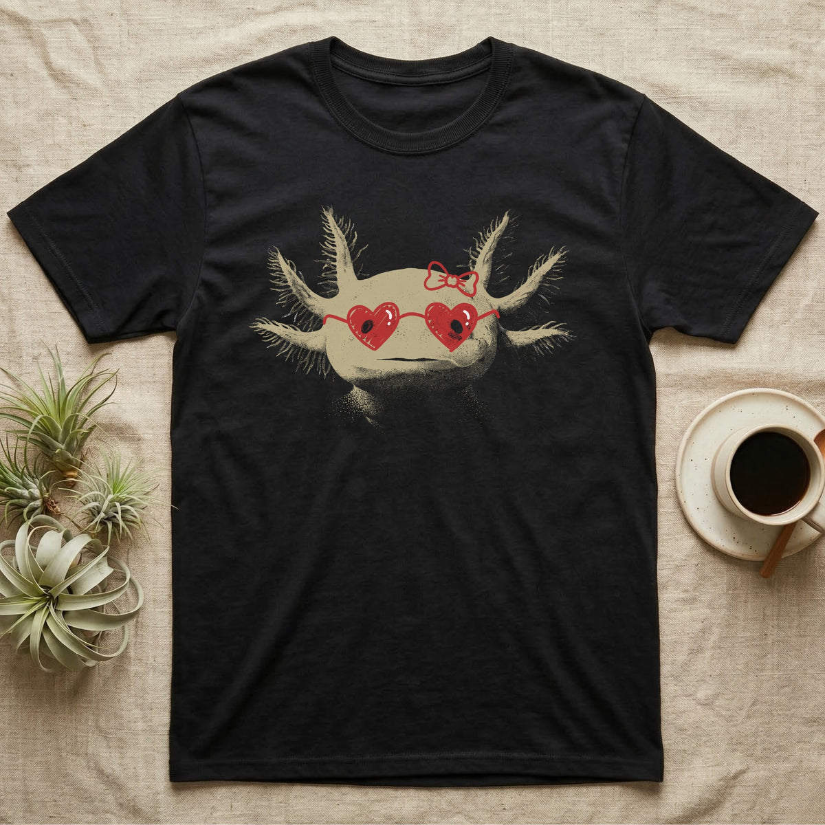 Axolotl Heart Glasses T-Shirt in Black — An axolotl's face with red marker heart-shaped sunglasses and a bow drawn on the glass.