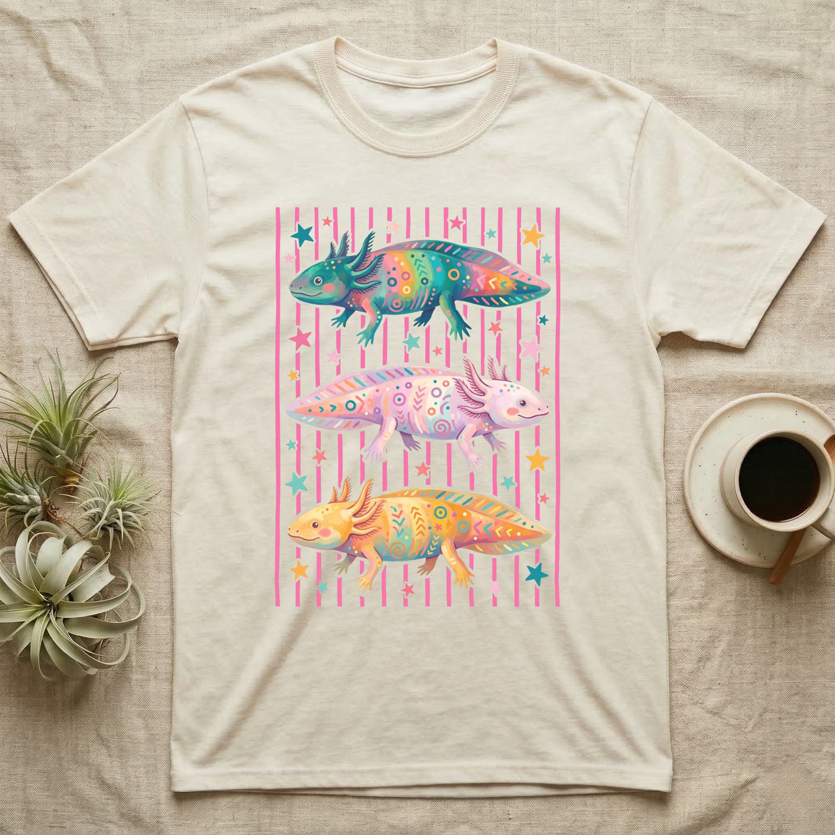Axolotl Colourways Candy Stripe T-Shirt in Natural — Three gouache axolotls stacked in bands on pink candy stripes, facing left, right and left, with scattered stars