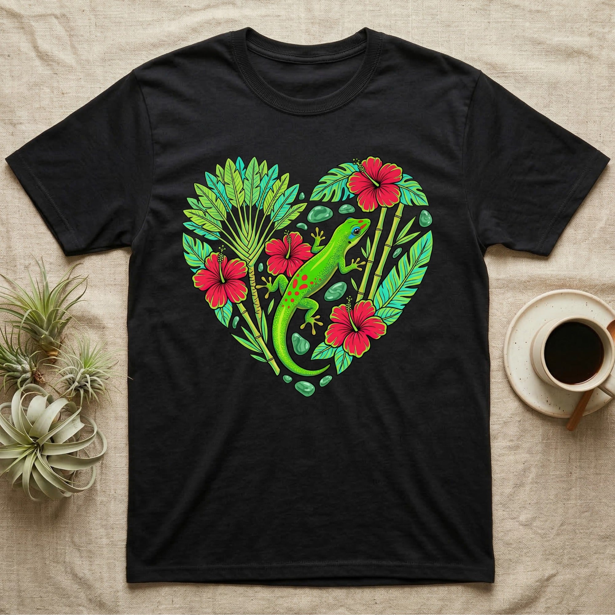 Black t-shirt with a heart-shaped design of a gecko, tropical leaves, and red hibiscus flowers.