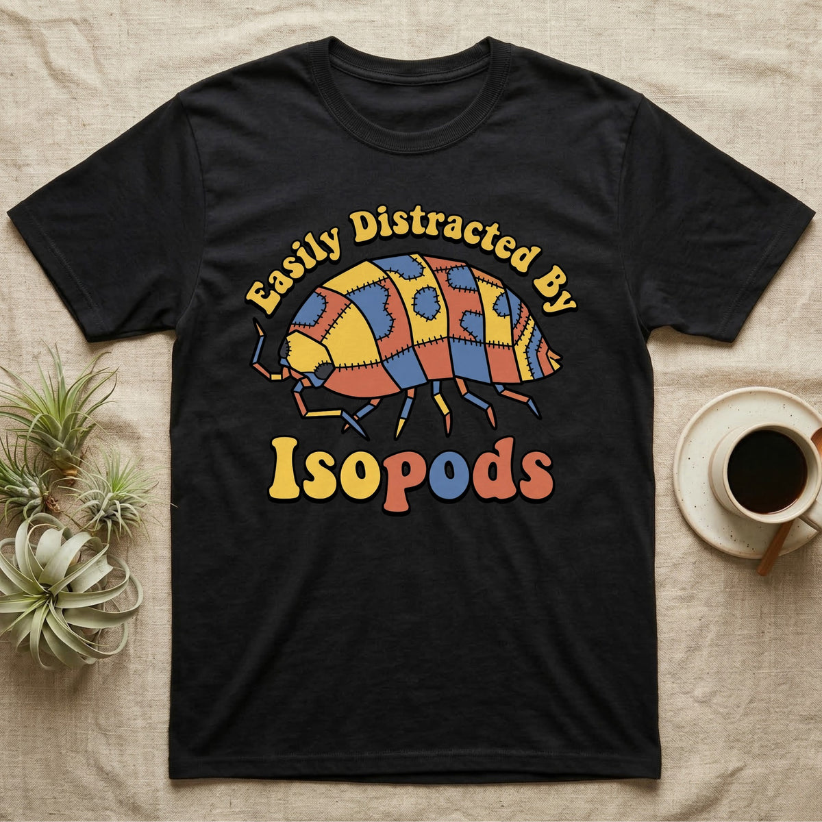 Dairy Cow Isopod Patchwork T-Shirt in Black — Quilt-patchwork dairy cow isopod in mustard and denim under retro "Easily Distracted By Isopods" text.