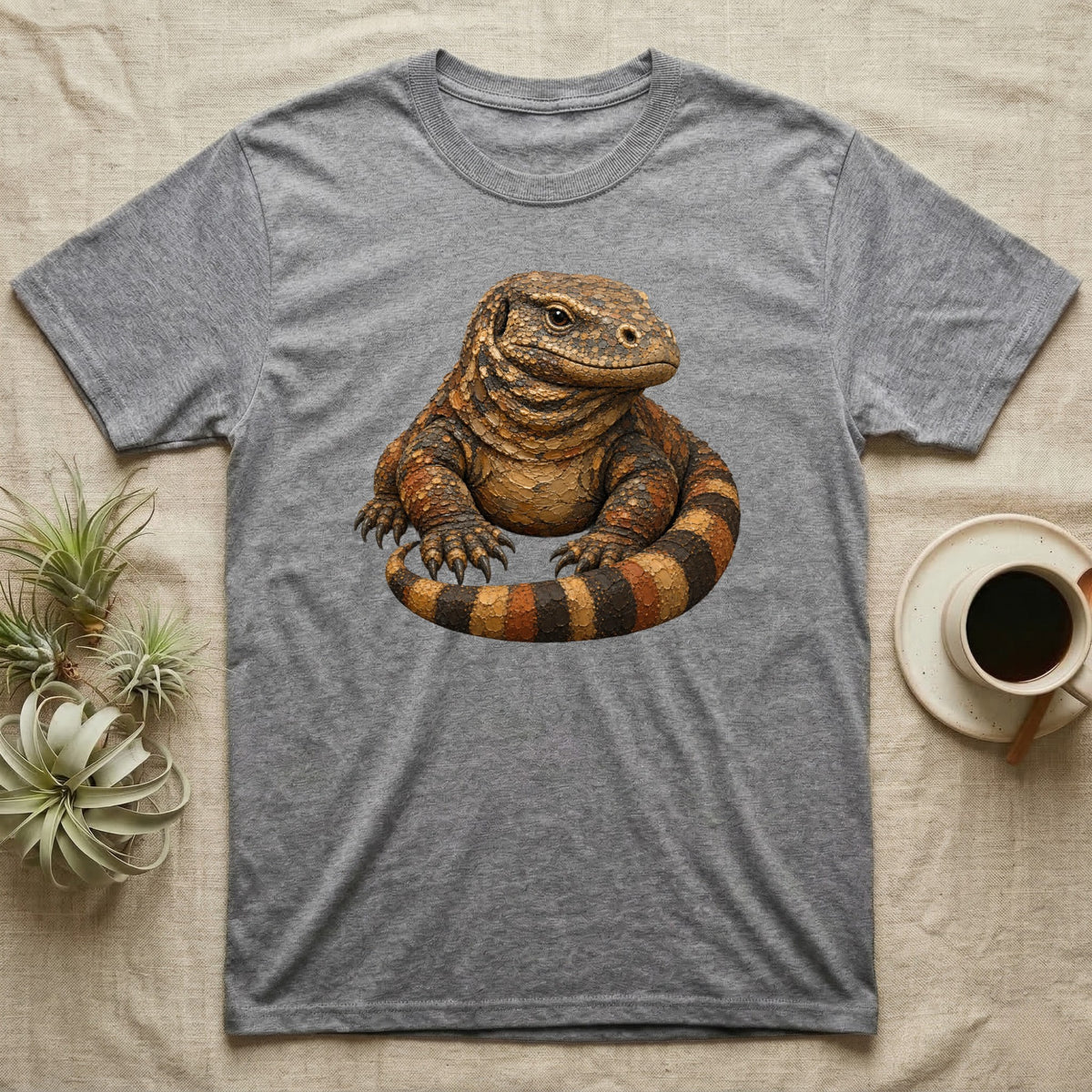 Grey t-shirt featuring a detailed illustration of a monitor lizard.