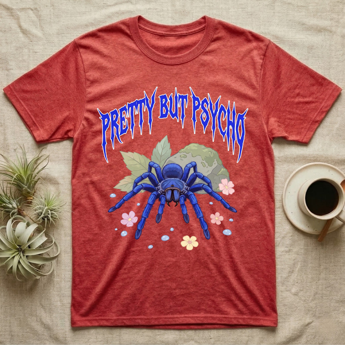 Cobalt Blue Tarantula Feral T-Shirt in Heather Red — Cobalt blue tarantula with electric-blue legs under jagged cobalt metal text PRETTY BUT PSYCHO with pastel blossoms