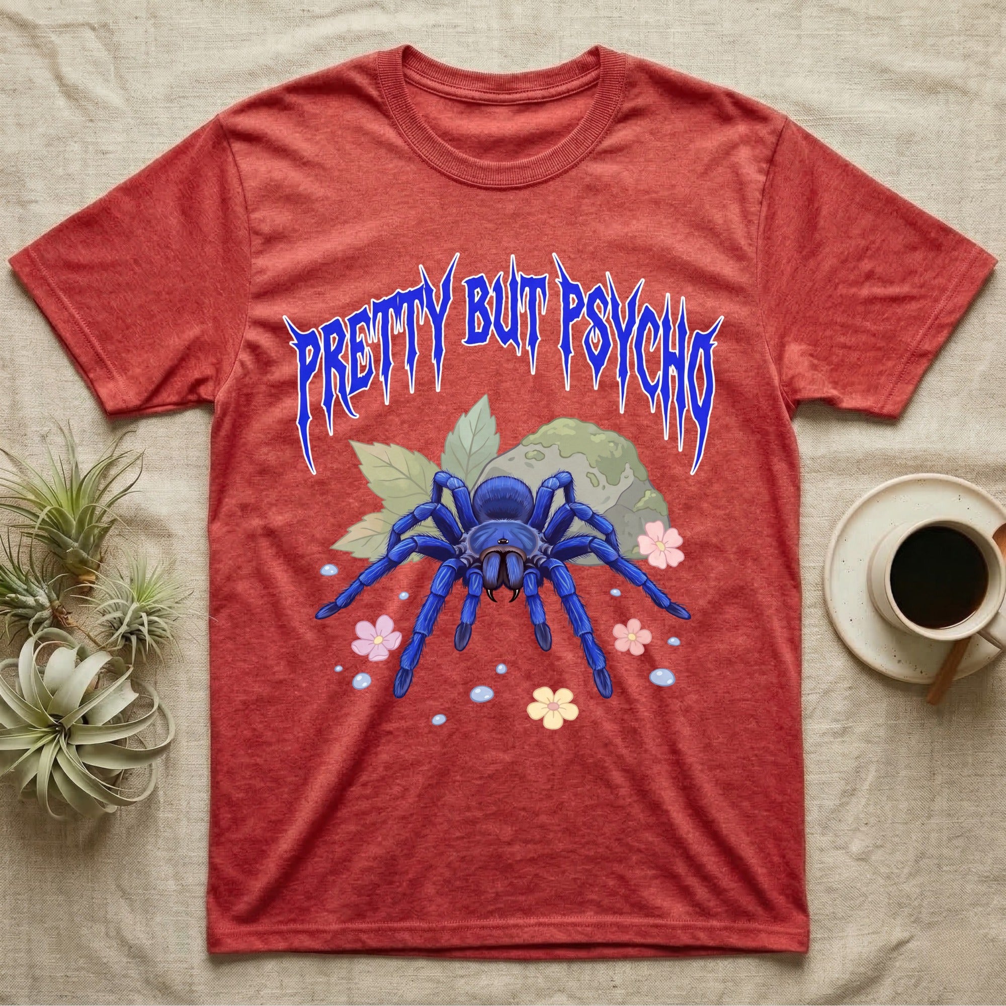 Cobalt Blue Tarantula Feral T-Shirt in Heather Red — Cobalt blue tarantula with electric-blue legs under jagged cobalt metal text PRETTY BUT PSYCHO with pastel blossoms