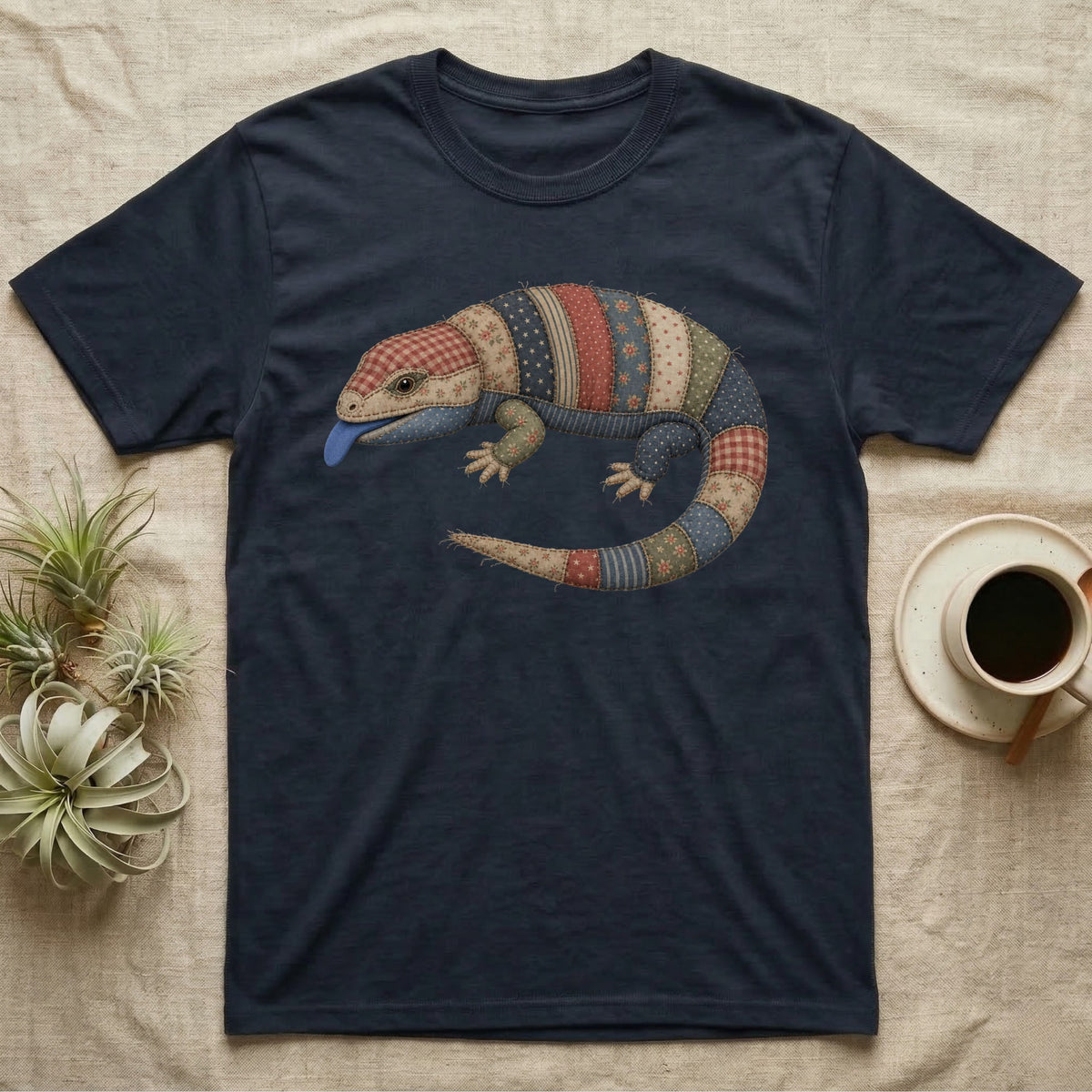 Navy t-shirt with a patchwork lizard graphic and a blue tongue.