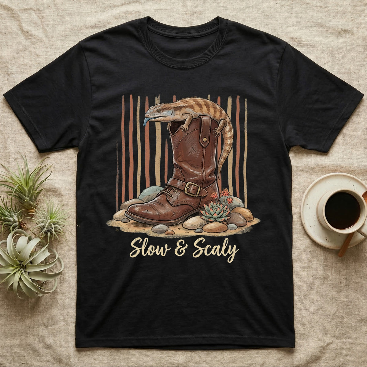 Black t-shirt with boot, lizard, succulents, and text "Slow & Scaly".