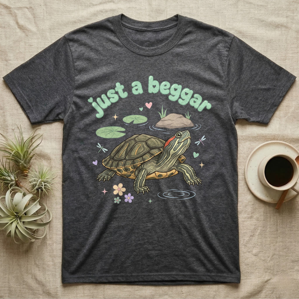 Red-Eared Slider Softie T-Shirt in Dark Heather — Red-eared slider turtle stretching its neck to beg, under pastel bubble text "just a beggar" with hearts.
