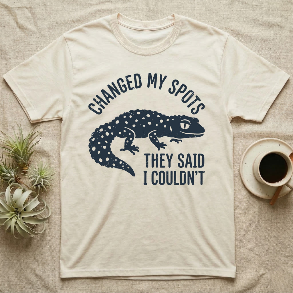 Leopard Gecko Spots T-Shirt in Natural — Navy silhouette of a spotted leopard gecko walking under arched words Changed My Spots, beside They Said I Couldn't