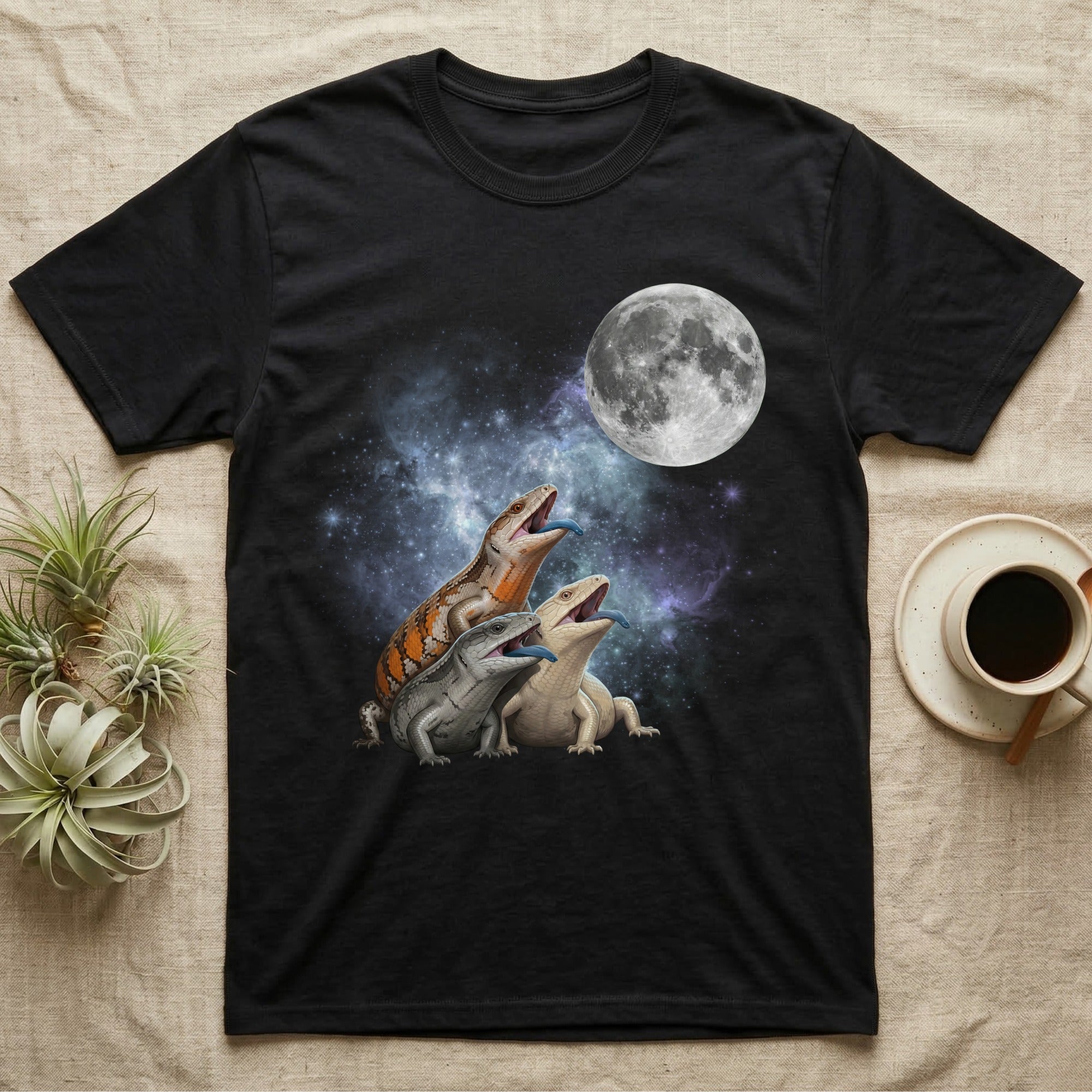 Blue-Tongued Skink Moon Howl T-Shirt in Black — Three Blue-Tongued Skink colour morphs howling at a full moon over a nebula on a dark grey t-shirt.