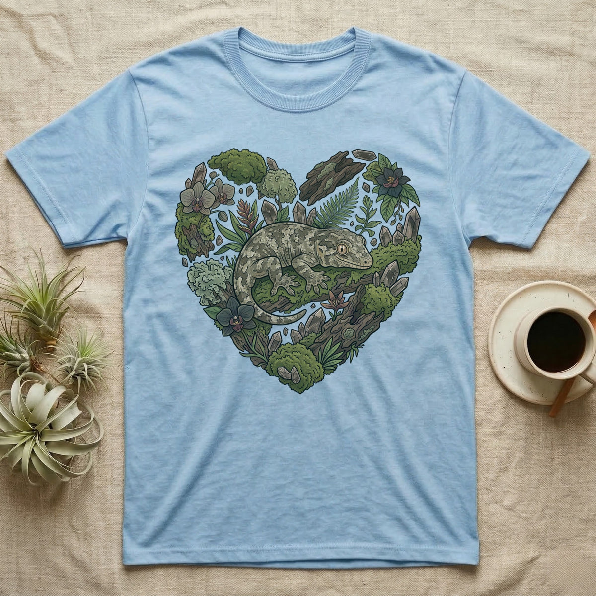 Light blue t-shirt with a heart-shaped nature design featuring a gecko.