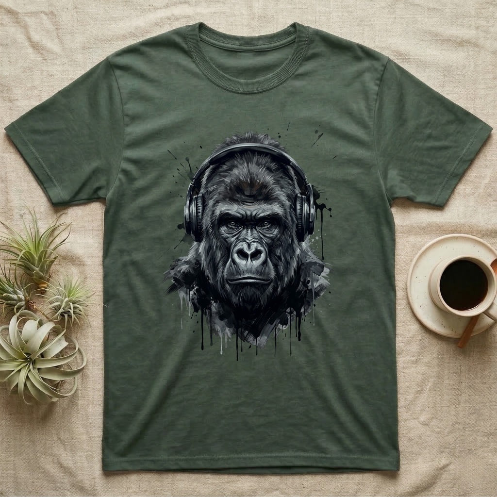 Gorilla wearing headphones with dark splatter art on a green t-shirt.