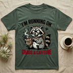 T-shirt with raccoon holding coffee mug, "Chaos & Caffeine" text.