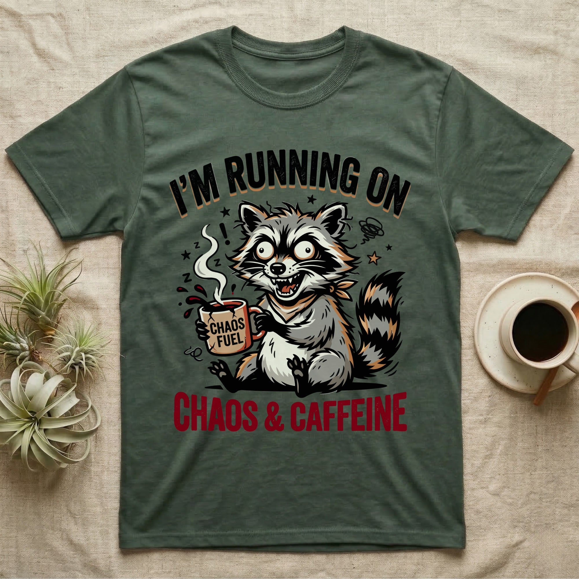 T-shirt with raccoon holding coffee mug, "Chaos & Caffeine" text.