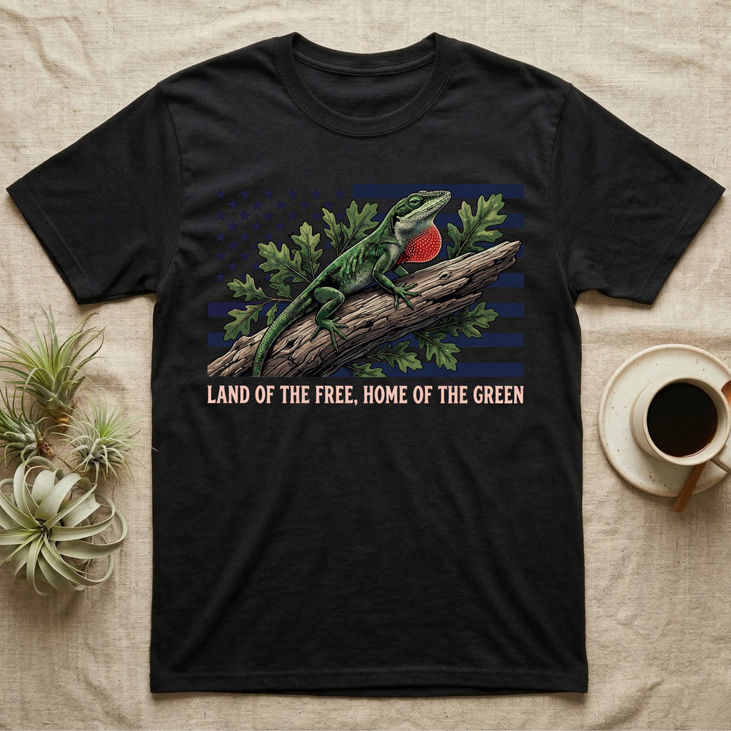 Green Anole 1776 T-Shirt in Black — Realistic green anole with a red dewlap on a branch over a distressed flag under text Land of the Free, Home of the Green.