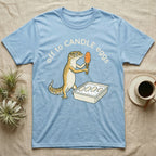 Leopard Gecko Candling T-Shirt in Light Blue — Leopard gecko holding a torch under a glowing orange egg beside a tub of eggs, under the words off to CANDLE eggs